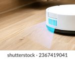 robot vacuum cleaner removes dirt from the floor in a room. There is a light sensor to detect small dust particles