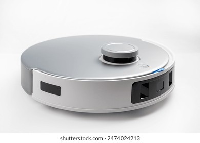 A robot vacuum cleaner with a round body and a silver and black color. The robot is on a white background