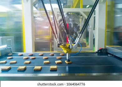 Robot With Vacuum Suckers With Conveyor In Production Of Cookies In A Manufacture Factory For The Food Industry 