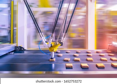 Robot With Vacuum Suckers With Conveyor In Production Of Cookies In A Manufacture Factory For The Food Industry