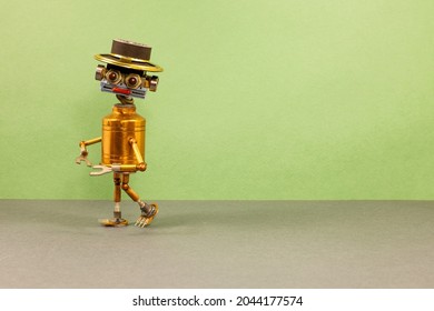 The robot is walking. Steampunk toy robotics character with a funny hat. green gray background copy space.