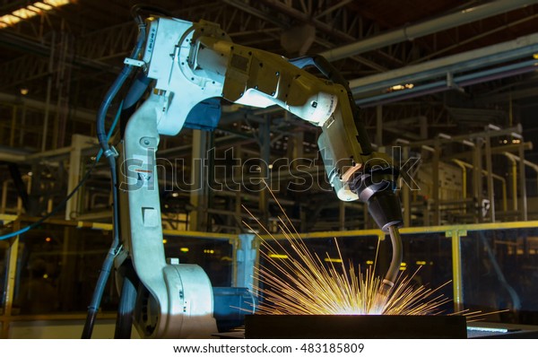 Robot welding\
automotive part in\
factory\
