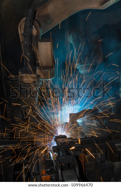 Robot welding\
car parts in automotive\
factory\
