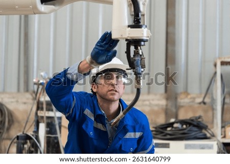 Robotic arm, Automatic robotic arm welding. Robotic manufacturing industry. Engineer setup, install, maintain, repair mechanism of operation of robotic arm in workshop