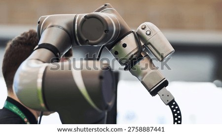Robotic arm collaborating with human operator demonstrating automation technology