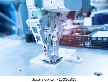 Robotic arm installing a computer chip