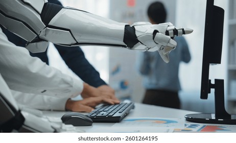 A robotic arm interacts with a computer in a modern office, embodying the spirit of innovation and collaboration in technology and artificial intelligence development.Noogenesis
