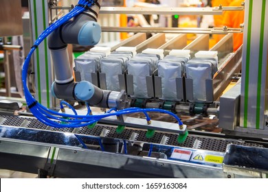 Robotic Arm Lifting Pouch For Seal Sensor Inspection. Food Industry