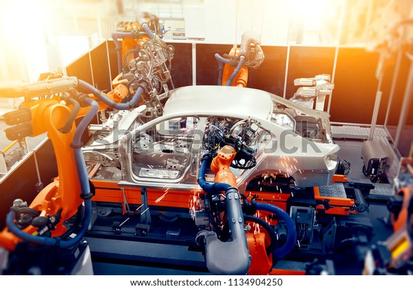 The\
robotic arm on the car production line is\
working