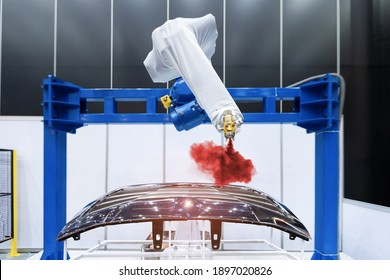 Robotic arm painting spray to the automotive part. High-technology manufacturing concept. - Powered by Shutterstock