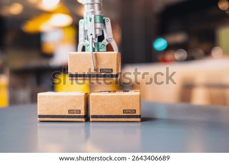 A robotic arm is picking up a tiny parcel box and lifting it up. The idea is to use AI and technology to help make parcel delivery more convenient and safe.