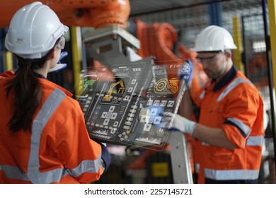 robotic arms. Engineer manager checking and controling automation robot arms machine in intelligent factory industrial on real time monitoring system software. digital manufacturing operation.