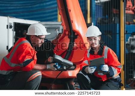 robotic arms. Engineer manager checking and controling automation robot arms machine in intelligent factory industrial on real time monitoring system software. digital manufacturing operation.