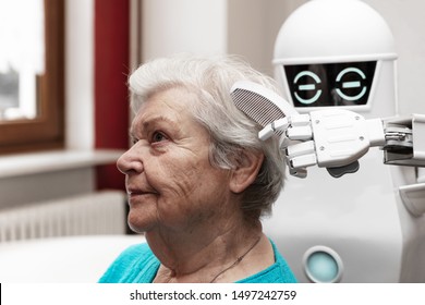 A Robotic Caregiver Is Combing The Hair Of A Female Senior Adult, Concepts Like Household Nursing Robot Or Helping Technology In Medicine