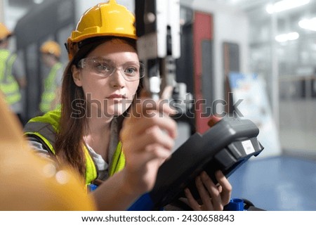 Robotic development engineer working robot arm connection and control at electronic futuristic science laboratory. Female technician learning smart innovation machine in automated engineering academy