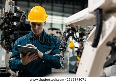 Robotic engineer automatic mechanic checking quality system of automation robot arms machine in factory. Service programming machinery welding robots in production at factory industry.