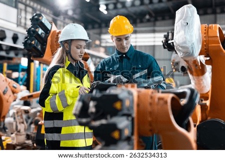 Robotic engineer team automatic checking Plan system of automation robot arms machine in factory. Programming machinery welding robots in production at factory industry.