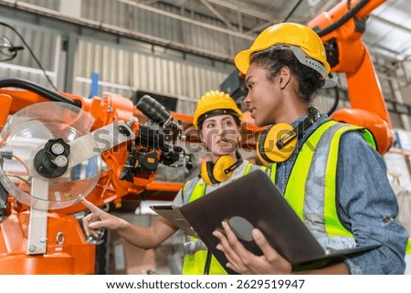 robotic engineer training, technician work in modern factory industrial robot welding arm machine control operator