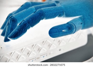 Robotic Hand Holding a Basic Computer Device
