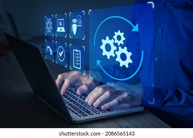 Robotic Process Automation (RPA) technology to automate business tasks with AI. Concept with expert setting up automated software on laptop computer. Digital transformation and change management.