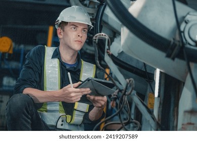 A robotic technician attentively performs preventive and corrective maintenance on machinery in a robot manufacturing factory. - Powered by Shutterstock