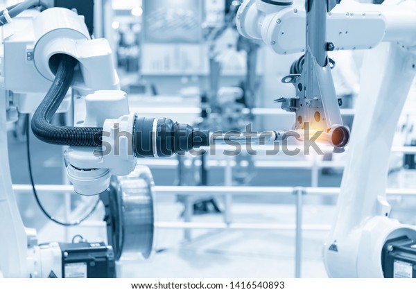 The robotics arm\
welding the automotive parts. The automobile  assembly  line with\
the autonomous  system.