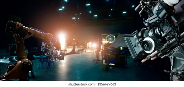 Robotics automatic arms machine of making movie and TV commercial in studio. Camera of movie. Innovation and technology of movie industry with monitoring system software. Film crew team in set. - Shutterstock ID 1356497663