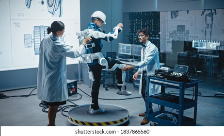 In Robotics Development Laboratory: Engineers And Scientists Work On A Bionics Exoskeleton Prototype With Person Testing It. Designing Wearable Exosuit To Help Disabled People, Warehouse Workers