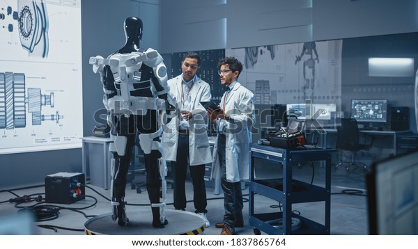 In Robotics Development Laboratory International\
Team of Engineers and Scientists Work on Robotics Exoskeleton\
Prototype. Designing Powered Exosuit to Help Disabled People Walk,\
Workers to Lift Goods