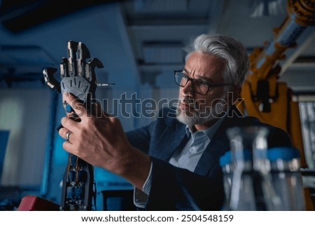 Robotics engineer adjusting, calibring robotic prosthetic hand. Concept of modern technology in medicine. Robotic prosthetics, biomechatronics and neuroscience.