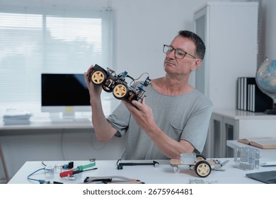 Robotics engineer examining a prototype of a robotic vehicle in his laboratory, surrounded by electronic components, tools, and a computer, focused on innovation and development