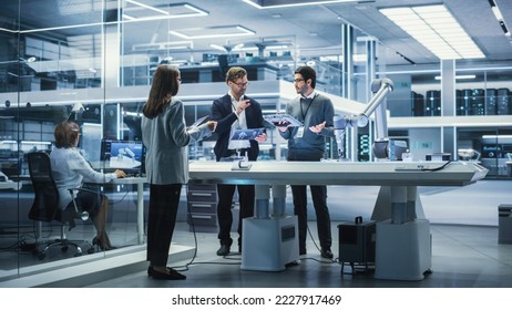 Robotics Engineer, Project Manager and Machinery Operator Collaborate on a Robot Arm Project, Standing with Tablet Computers in Scientific Technology Lab. Young Team Developing an AI Robotic Arm.