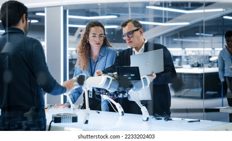 Robotics Engineer, Project Manager and Machinery Operators Collaborate on a Robot Machine Project, Standing with Laptop Computer in Scientific Technology Lab. Young Team Developing an AI Robotic Dog. - Shutterstock ID 2233202403