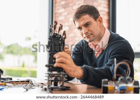 Robotics Engineer Working on Advanced Prosthetic Arm, Man Assembles Bionic Hand Prototype, Scientist Developing Robotic Limb, Innovation in Progress