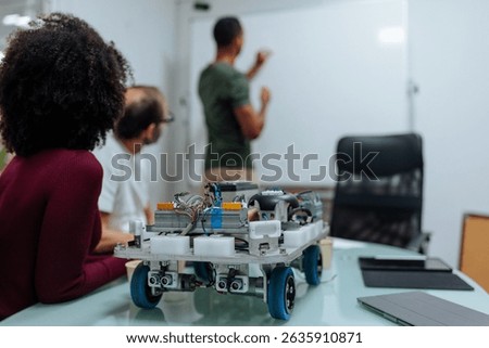 Robotics engineers testing a robot prototype in a high-tech laboratory, showcasing innovation and collaboration in the field of artificial intelligence