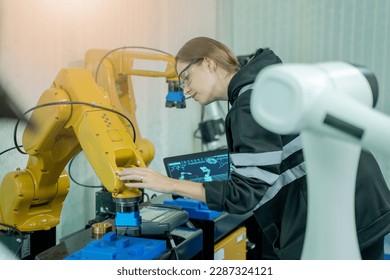 Robotics industry concept,Robotics control engineers setting and maintain spare parts of industrial robot arm controller in production plant factory. - Powered by Shutterstock