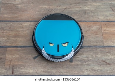 Robots Takeover, Robots As Pets And Evil Robots Concepts. Robot Vacuum Cleaner On The Floor With Eyes And Evil Smile.