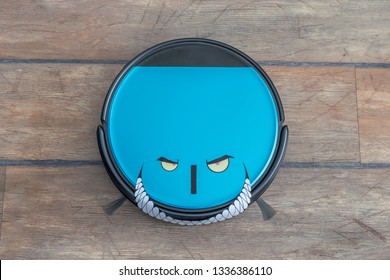 Robots Takeover, Robots As Pets And Evil Robots Concepts. Robot Vacuum Cleaner On The Floor With Eyes And Evil Smile.