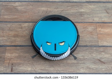 Robots Takeover, Robots As Pets And Evil Robots Concepts. Robot Vacuum Cleaner On The Floor With Eyes And Evil Smile.