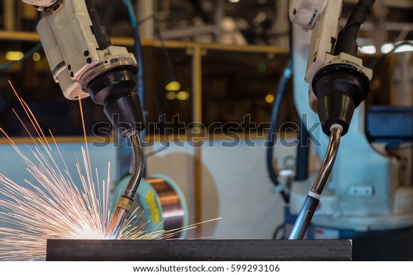 Robots are\
welding automotive part in car\
factory