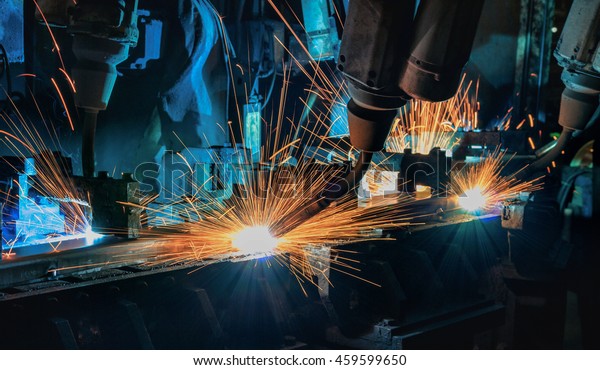 Robots welding\
automotive part in\
factory\
