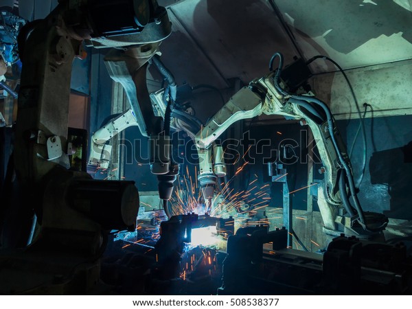 Robots\
welding are team work in automotive\
industrial.\
