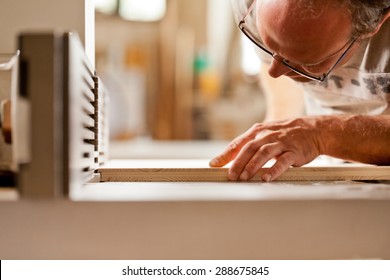 Robust Hand Of A Man Working On A Wood Shaper (spindle Moulder) In A Carpenter Workshop, Detail Of The Joiner's Head Checking