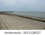 Robust river side construction featuring concrete pier, pillared structure, and scenic waterfront pathway