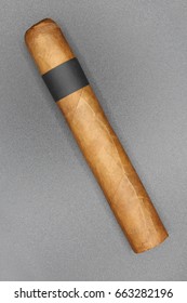 Robusto Cigar With Light Wrapper And Black Ring On Grey Background.