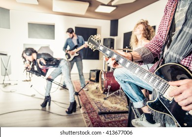 Rock Band Recording A Music Track In A Studio - Friends Performing Music In A Recording Studio