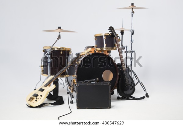 Rock Band, solo guitar, bass, drums, microphone\
on a black suitcase.