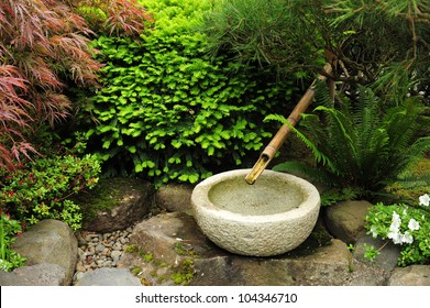 A Rock Bowl With Bamboo Tube In Japanese Garden