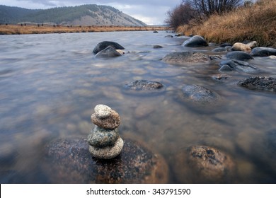 A Rock Cairn Is On A Wet Rock In The Salmon River Near Stanley, Idaho.