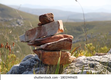 A rock cairn (rock stack) on top of a mountain.  - Powered by Shutterstock